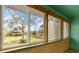 Sunroom balcony featuring neutral tones, wood accents, and green outdoor views at 4346 Rayfield Dr # 4346, Sarasota, FL 34243