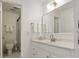 Bright bathroom with white cabinets, a marble countertop, and a glass door shower at 4346 Rayfield Dr # 4346, Sarasota, FL 34243