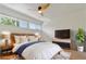 Staged bedroom with hardwood floors, a ceiling fan, and natural light at 4346 Rayfield Dr # 4346, Sarasota, FL 34243