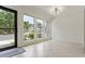 Bright dining room featuring large windows, light tile flooring, and all white walls at 4346 Rayfield Dr # 4346, Sarasota, FL 34243