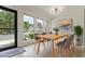 Bright dining room featuring a modern light fixture, a wooden table, and large windows at 4346 Rayfield Dr # 4346, Sarasota, FL 34243