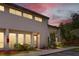 Charming two-story townhome with a well-manicured lawn and beautiful landscaping at dusk at 4346 Rayfield Dr # 4346, Sarasota, FL 34243