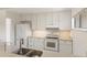 Bright kitchen with white cabinets, modern appliances, and a stainless steel sink at 4346 Rayfield Dr # 4346, Sarasota, FL 34243