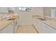 Kitchen featuring white cabinets, stainless steel sink, and plenty of counter space at 4346 Rayfield Dr # 4346, Sarasota, FL 34243