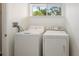 Laundry room featuring a washer, dryer, and natural light at 4346 Rayfield Dr # 4346, Sarasota, FL 34243