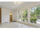 Living room with tile flooring, large windows offering a view of lush greenery outside at 4346 Rayfield Dr # 4346, Sarasota, FL 34243
