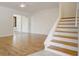 Cozy living room with hardwood floors, stairway, and sliding door to a patio area at 4346 Rayfield Dr # 4346, Sarasota, FL 34243
