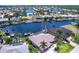 Scenic aerial view of waterfront home boasting a private boat dock, screened pool, and stunning canal access at 523 Saint Girons Ct, Punta Gorda, FL 33950