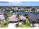 An aerial view shows the property's canal-front location, lush landscaping, and proximity to water access at 523 Saint Girons Ct, Punta Gorda, FL 33950