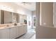 Bright bathroom featuring double vanity, white cabinets and shiplap accent wall at 523 Saint Girons Ct, Punta Gorda, FL 33950