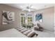 Airy bedroom with plantation shutters, side chair, and vibrant wall art at 523 Saint Girons Ct, Punta Gorda, FL 33950