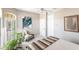 Bright bedroom with chair, throw blanket, and ample natural light from windows at 523 Saint Girons Ct, Punta Gorda, FL 33950