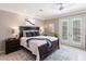 This is a primary bedroom with a king bed, an area rug, and French doors at 523 Saint Girons Ct, Punta Gorda, FL 33950
