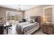 This is a nicely furnished bedroom with a ceiling fan and plantation shutters at 523 Saint Girons Ct, Punta Gorda, FL 33950