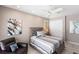 Inviting bedroom featuring a ceiling fan, plantation shutters, and wall art at 523 Saint Girons Ct, Punta Gorda, FL 33950