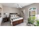 Comfortable bedroom with a queen-size bed, ceiling fan, and tile flooring at 523 Saint Girons Ct, Punta Gorda, FL 33950