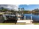 View of a private boat dock with boat lift on a waterfront canal at 523 Saint Girons Ct, Punta Gorda, FL 33950