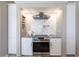 Kitchen showcases a stainless steel range under a sleek vent hood and white marble backsplash at 523 Saint Girons Ct, Punta Gorda, FL 33950