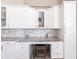 Close up of the bright kitchen desk with white cabinetry and marble backsplash at 523 Saint Girons Ct, Punta Gorda, FL 33950