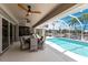 Covered lanai with outdoor seating, pool, and canal views at 523 Saint Girons Ct, Punta Gorda, FL 33950