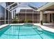 Relaxing screened pool area with hot tub offers poolside lounging, perfect for enjoying the Florida lifestyle at 523 Saint Girons Ct, Punta Gorda, FL 33950