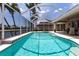 The stunning screened pool features a spa and offers views of the serene waterfront, ideal for leisure and enjoyment at 523 Saint Girons Ct, Punta Gorda, FL 33950
