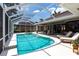 The screened-in pool and spa area offers a relaxing space with comfortable seating for enjoying outdoor living at 523 Saint Girons Ct, Punta Gorda, FL 33950