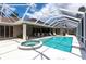 A beautiful screened pool area features a pool, spa, and outdoor seating, perfect for relaxation and entertaining at 523 Saint Girons Ct, Punta Gorda, FL 33950