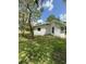 Backyard featuring a well-maintained lawn and mature trees at 5727 Beechwood St, Punta Gorda, FL 33982