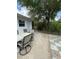 Backyard patio features a comfortable seating area next to the house at 5727 Beechwood St, Punta Gorda, FL 33982