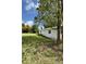 Backyard featuring a well-maintained lawn and mature trees offering ample shade at 5727 Beechwood St, Punta Gorda, FL 33982