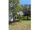 Backyard featuring a well-maintained lawn and mature trees offering ample shade at 5727 Beechwood St, Punta Gorda, FL 33982