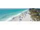 Scenic aerial view of a sunny beach with clear turquoise water and many people relaxing and enjoying the day at 5727 Beechwood St, Punta Gorda, FL 33982