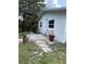 Charming white home with a welcoming walkway and colorful potted plants for a touch of curb appeal at 5727 Beechwood St, Punta Gorda, FL 33982