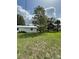 Expansive green property with mature trees surrounding a single-story home, creating a private and serene setting at 5727 Beechwood St, Punta Gorda, FL 33982