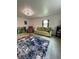 Inviting living room with tile flooring, a plush area rug, and cozy seating, perfect for relaxing and entertaining at 5727 Beechwood St, Punta Gorda, FL 33982