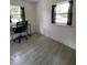 Simple office space with wood-look tile flooring and natural light from two windows at 5727 Beechwood St, Punta Gorda, FL 33982