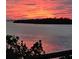 Scenic waterfront view featuring a vibrant sunset over the water, creating a serene and picturesque setting at 5727 Beechwood St, Punta Gorda, FL 33982