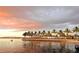 Sunset view over water with palm trees and a building, showing a tropical destination at dusk at 5727 Beechwood St, Punta Gorda, FL 33982