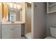 Bathroom featuring a walk-in shower, mirrored vanity, and neutral paint at 711 Forest Hill Nw Ln, Port Charlotte, FL 33948