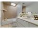 Bathroom with neutral vanity, skylight, and combination shower and tub at 711 Forest Hill Nw Ln, Port Charlotte, FL 33948
