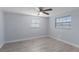 Unfurnished bedroom showing new wood-look floors, ceiling fan, and natural light at 711 Forest Hill Nw Ln, Port Charlotte, FL 33948