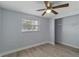 Bedroom with ceiling fan, natural light, and walk in closet at 711 Forest Hill Nw Ln, Port Charlotte, FL 33948