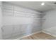 Walk-in closet with white wire shelving and wood flooring at 711 Forest Hill Nw Ln, Port Charlotte, FL 33948