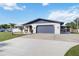 Well-maintained single-story home with a two-car garage and a beautiful, spacious concrete driveway at 711 Forest Hill Nw Ln, Port Charlotte, FL 33948