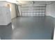 Spacious garage with an expansive smooth flooring and ample room for parking and storage at 711 Forest Hill Nw Ln, Port Charlotte, FL 33948