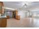 Spacious kitchen featuring wood cabinetry, a breakfast bar, and tile flooring at 711 Forest Hill Nw Ln, Port Charlotte, FL 33948