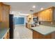 Bright kitchen featuring wood cabinets, stainless steel appliances, and tile backsplash at 711 Forest Hill Nw Ln, Port Charlotte, FL 33948