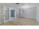 Spacious living room featuring tiled floors, French doors, and neutral paint at 711 Forest Hill Nw Ln, Port Charlotte, FL 33948