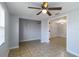 Neutral living room featuring tiled floors, walk-in closet, and modern light fixture at 711 Forest Hill Nw Ln, Port Charlotte, FL 33948